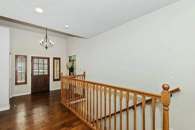 entrance foyer featuring a notable chandelier and dark wood-type flooring