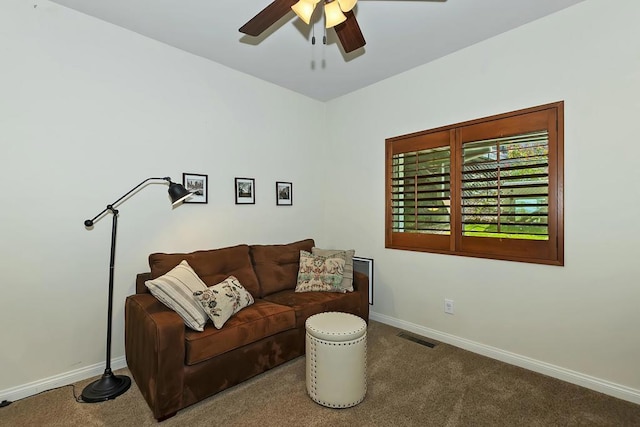 carpeted living room with ceiling fan