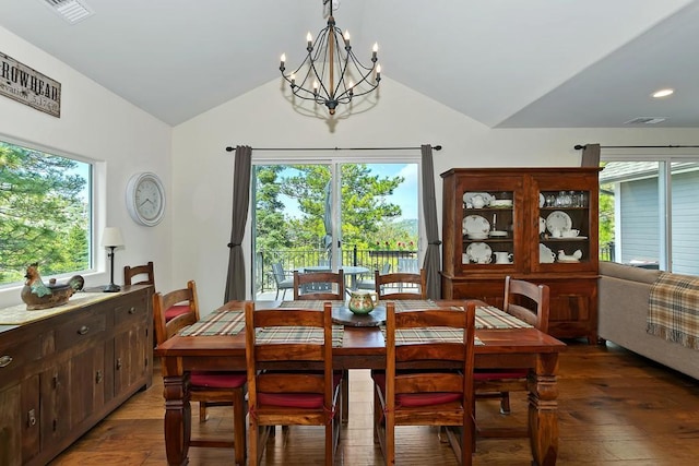 dining room with a notable chandelier, lofted ceiling, dark hardwood / wood-style flooring, and plenty of natural light