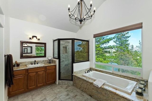 bathroom with vanity, vaulted ceiling, and independent shower and bath