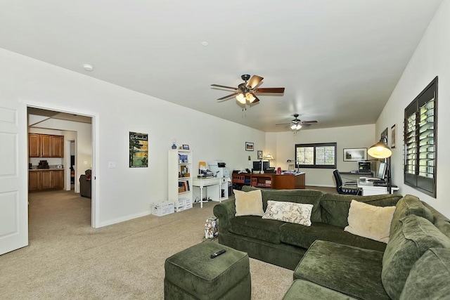 living room with ceiling fan and light colored carpet