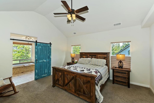 bedroom with multiple windows, a barn door, carpet, and ceiling fan