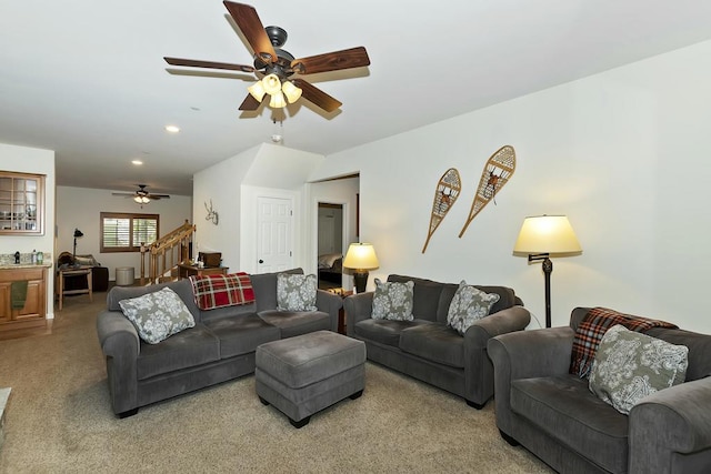 carpeted living room with ceiling fan