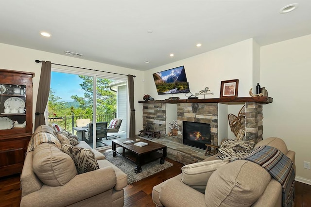 living room with a fireplace and dark hardwood / wood-style flooring