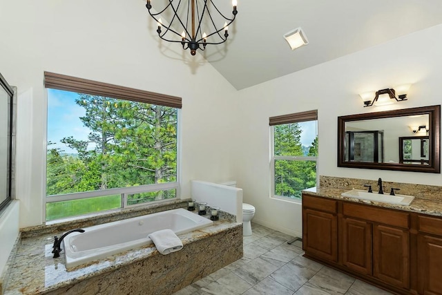 bathroom with vanity, a notable chandelier, tiled bath, vaulted ceiling, and toilet