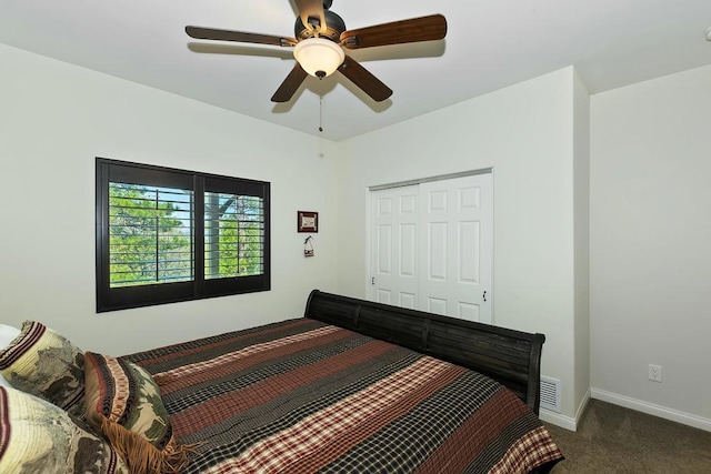 carpeted bedroom with ceiling fan and a closet