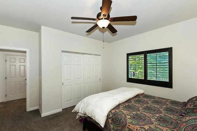 bedroom featuring dark carpet, a closet, and ceiling fan