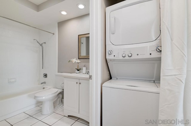 laundry area with stacked washer and dryer and light tile patterned flooring