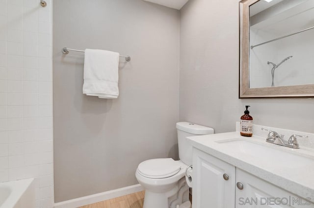 full bathroom with shower / bath combination, vanity, hardwood / wood-style floors, and toilet