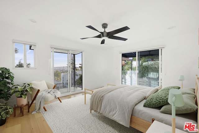 bedroom featuring ceiling fan, access to exterior, and light hardwood / wood-style flooring