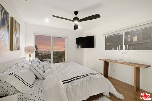 bedroom with wood-type flooring and ceiling fan