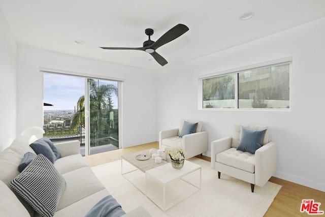 living area featuring ceiling fan and light wood-type flooring