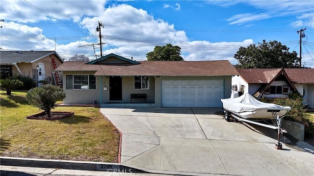 view of front of property with a garage and a front yard