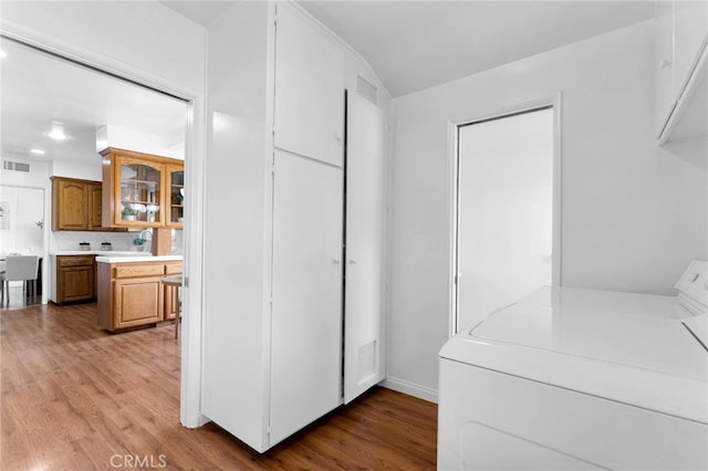 laundry room featuring wood-type flooring