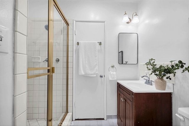 bathroom featuring an enclosed shower, vanity, and toilet