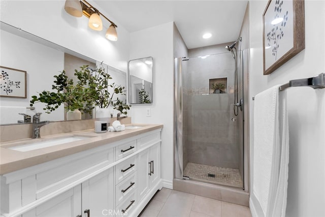 bathroom with tile patterned flooring, vanity, and walk in shower