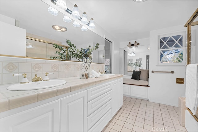 bathroom with vanity, backsplash, and tile patterned flooring