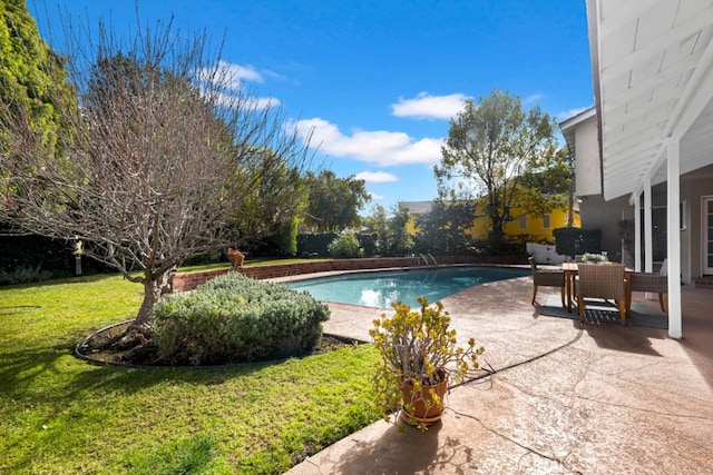 view of swimming pool featuring a yard and a patio area