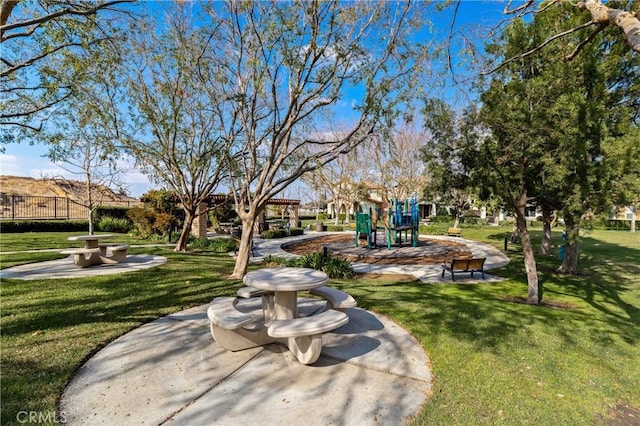 view of home's community with a lawn and a playground