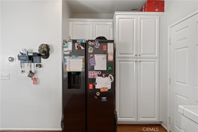 kitchen featuring fridge with ice dispenser and white cabinets