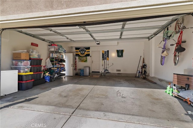 garage with a garage door opener and a carport