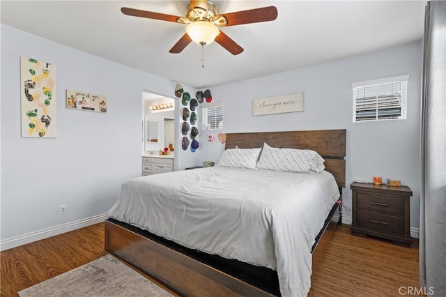 bedroom featuring dark hardwood / wood-style floors, ceiling fan, and ensuite bathroom