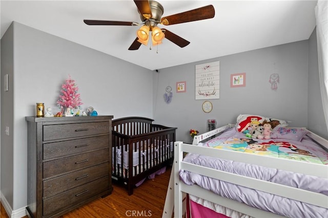 bedroom featuring ceiling fan and dark hardwood / wood-style flooring