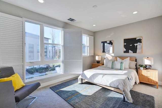 carpeted bedroom featuring multiple windows