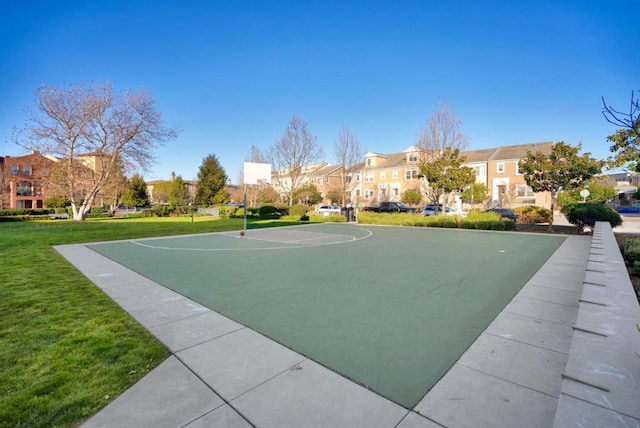 view of sport court featuring a lawn