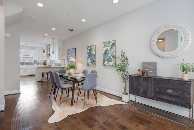 dining space featuring dark hardwood / wood-style floors