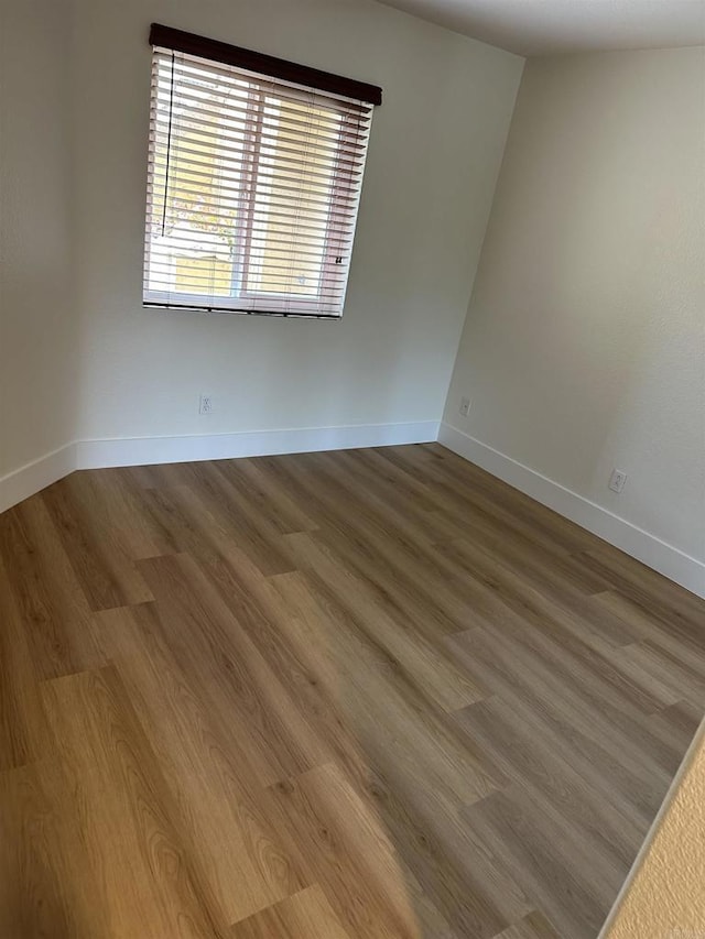 unfurnished room featuring hardwood / wood-style floors