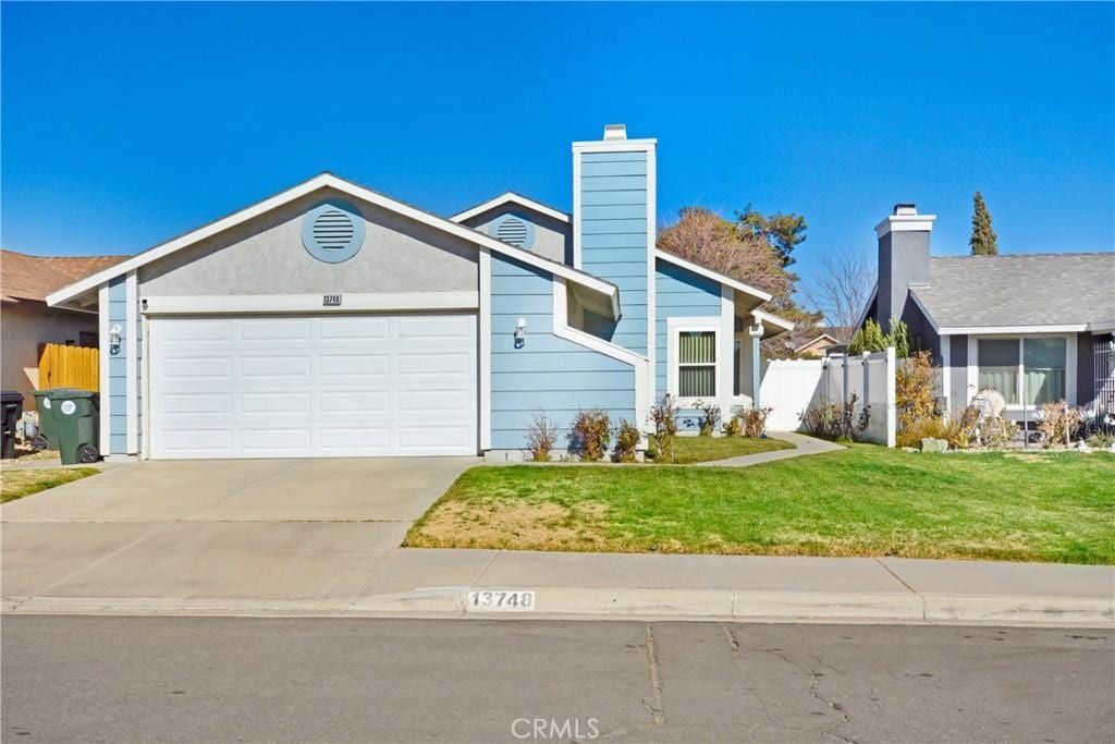 view of front of home with a garage and a front yard