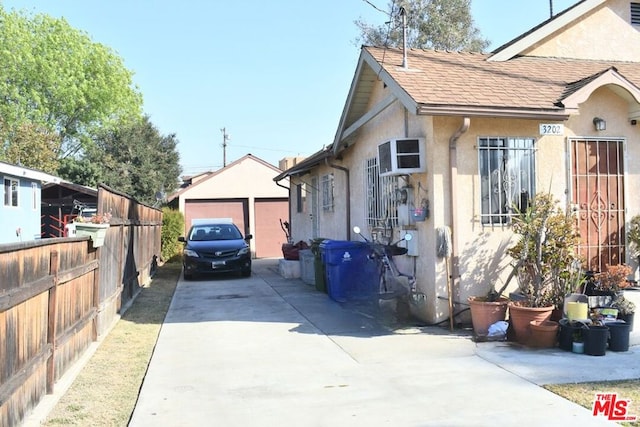 view of side of property featuring an outbuilding and a garage