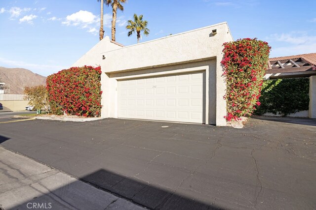 exterior space with a garage and a mountain view