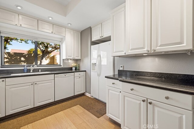 kitchen featuring white cabinetry, white appliances, and sink