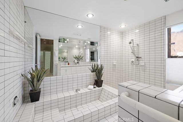 bathroom with tile walls and vanity