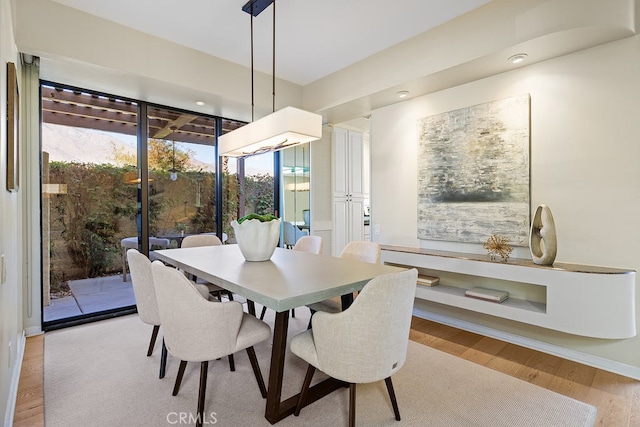 dining area featuring light wood-type flooring