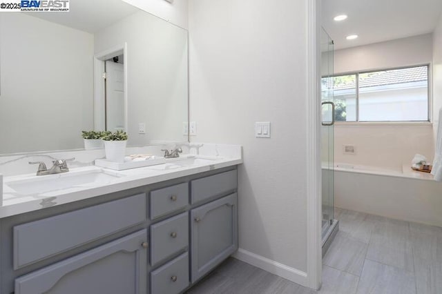 bathroom featuring vanity and shower with separate bathtub