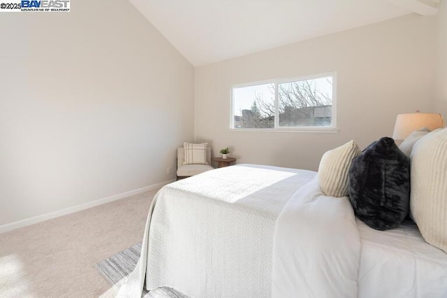 bedroom featuring vaulted ceiling and carpet