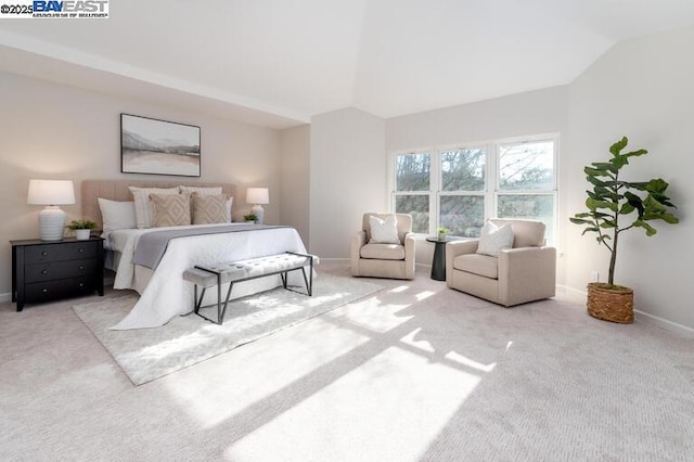 carpeted bedroom featuring lofted ceiling