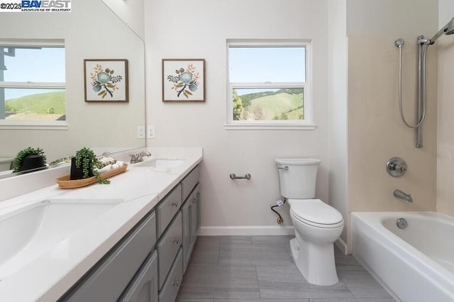 full bathroom with shower / bath combination, vanity, tile patterned floors, and toilet