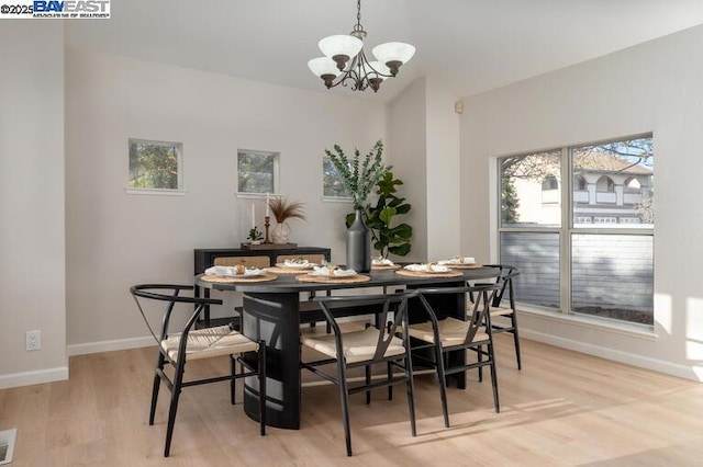 dining space featuring a chandelier and light hardwood / wood-style floors