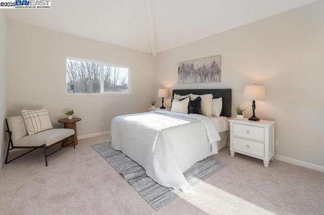 carpeted bedroom featuring vaulted ceiling