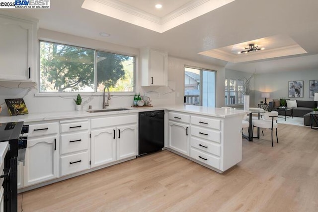 kitchen with sink, white cabinetry, black dishwasher, a tray ceiling, and kitchen peninsula