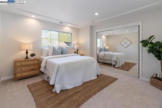 bedroom featuring a closet and light carpet