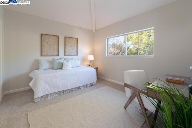 carpeted bedroom featuring lofted ceiling