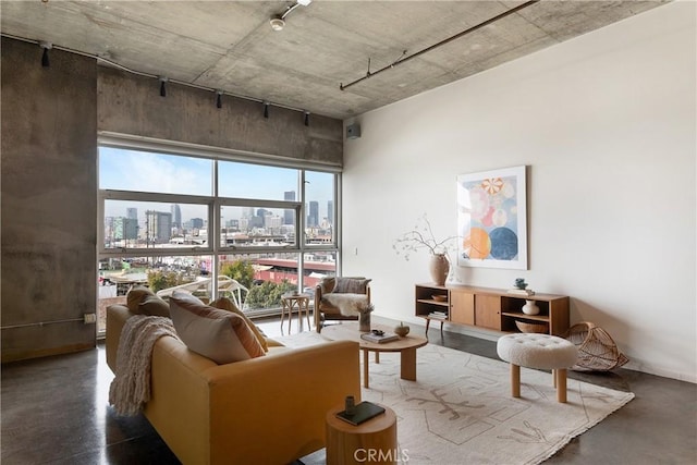 living area featuring a city view and finished concrete flooring