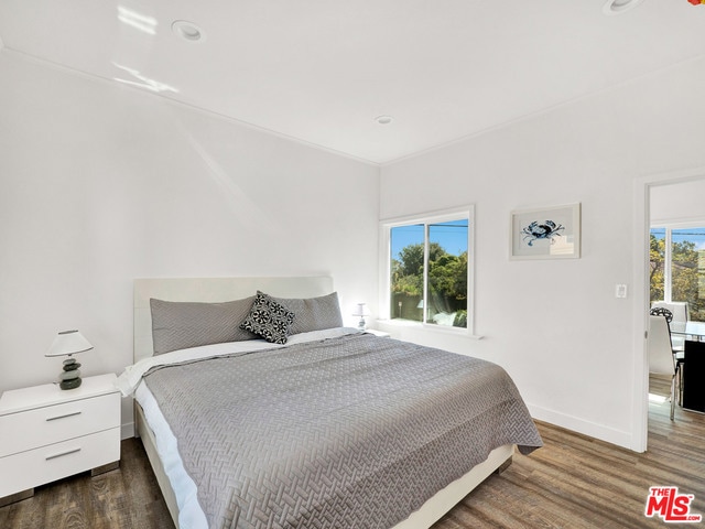 bedroom with dark hardwood / wood-style flooring