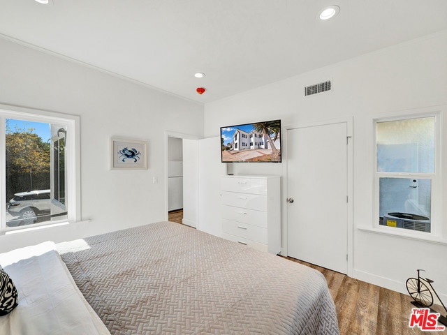 bedroom with hardwood / wood-style flooring