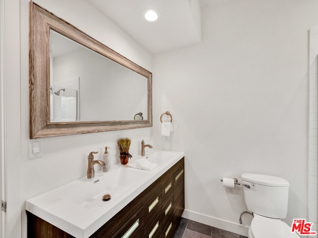 bathroom featuring vanity and toilet